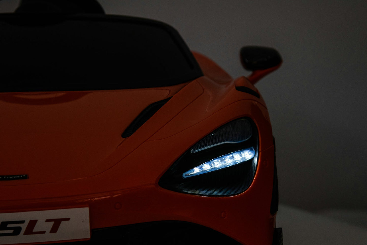McLaren 765LT 12V Kids Ride-On Car in orange with rubber tires, leather seat, LED lights, butterfly doors, parental remote control, and rechargeable battery.
electric-powered kids ride on car McLaren 765LT 12v