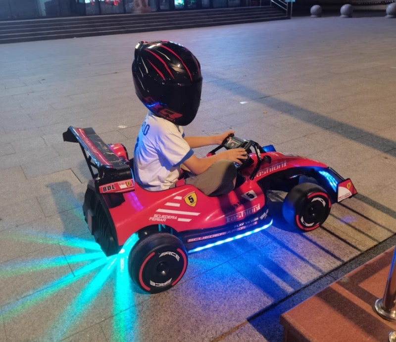 Formula F1 24V Kids Ride-On Go-Kart with brushless motor, drifting rear wheels, LED glow lights, leather seat, Bluetooth stereo, parental remote control, metal chassis, and dual-size adjustable pedals for kids and small adults. High-speed 24V battery-powered electric racing go-kart for ultimate fun and performance