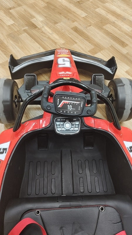 Formula F1 24V Kids Ride-On Go-Kart with brushless motor, drifting rear wheels, LED glow lights, leather seat, Bluetooth stereo, parental remote control, metal chassis, and dual-size adjustable pedals for kids and small adults. High-speed 24V battery-powered electric racing go-kart for ultimate fun and performance