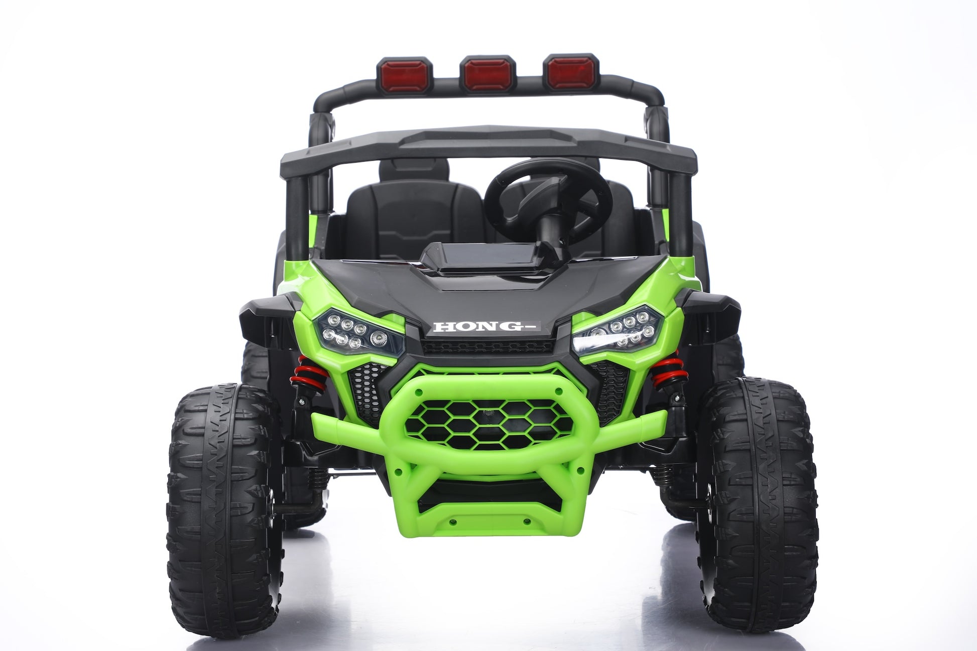 A bright lime green and black kids' electric ride-on UTV toy with a roll cage, large off-road tires, and a roof-mounted light bar, shown from the front on a white background.