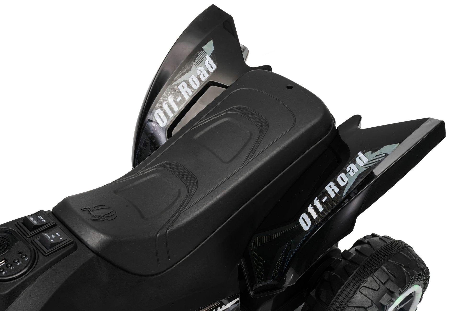 Close-up of a black off-road vehicle body with 'Off-Road' decals, showing the seat area and rugged tire against a white background.